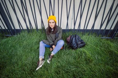 Top view urban portrait serious daring hipster girl sitting on grass Stock Photos