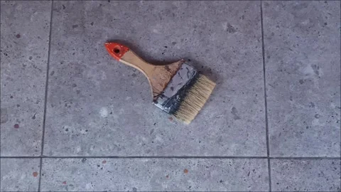 Top View of Used Paint Brush on Grey Stone Tile Floor Surface Video stock 331914374