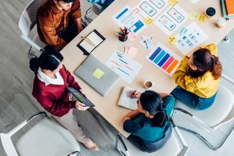 Top view ux developer and ui designer presenting mobile app interface with su Stock Photos