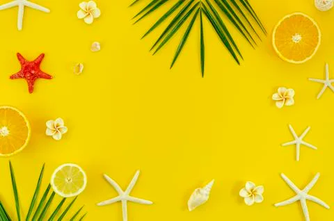 Top view vacantion flat lay frame on yellow background with palm, starfishes and Stock Photos