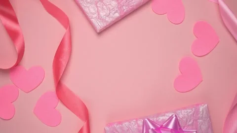 Top view of Valentines day decor, pink gift box, heart and ribbon Stock Footage 297622100