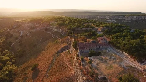 Top view of the valley with cliffs and forest. the medieval houses. sunset Stock Footage 125329336