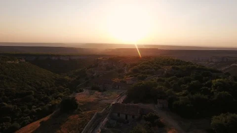 Top view of the valley with cliffs and forest. the medieval houses. sunset Stock Footage 125354529