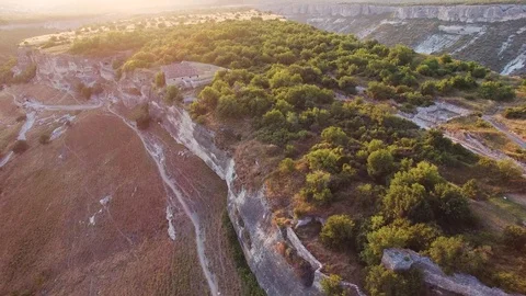 Top view of the valley with cliffs and forest. the medieval houses. sunset Stock Footage 125354560