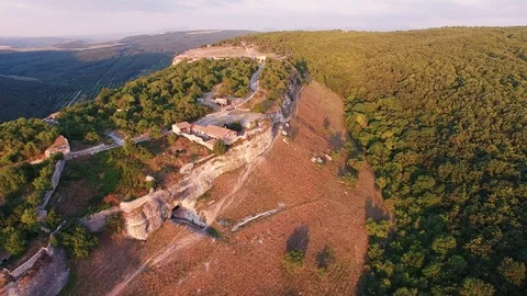 Top view of the valley with cliffs and forest. the medieval houses. sunset Stock Footage 125354571