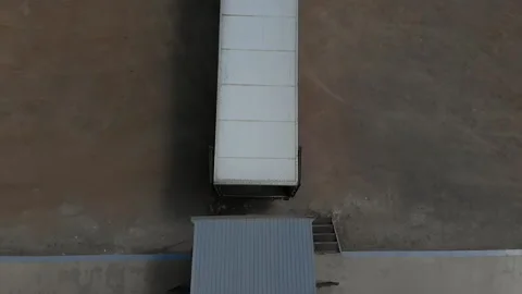 Top view of a van that parks at the warehouse. The driver of a large car Stock Footage 133230707
