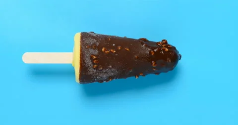 Top view vanilla flavor with chocoate and peanuts outer popsicle melting Stock Footage 136020739