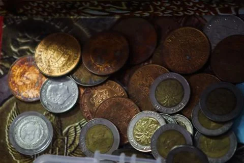 Top view of various ancient coins including bimetallic and colonial currency Stock Photos