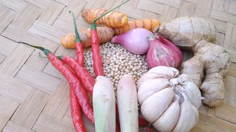 Top view of various Indonesian cooking spices and herbs on a rustic wooden board Stock Footage 340618669