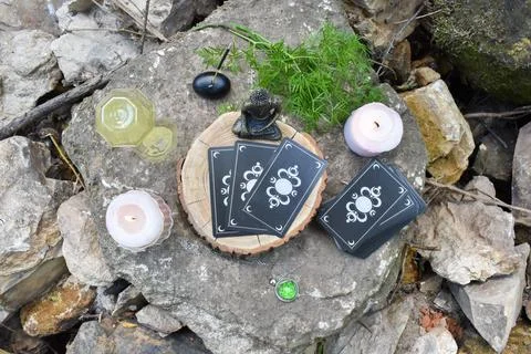 Top view of various objects for rituals and divination on a large stone against Фото