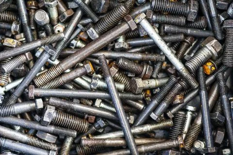 ​Top view of various old rusty steel bolts and industrial metal fasteners piled 写真素材