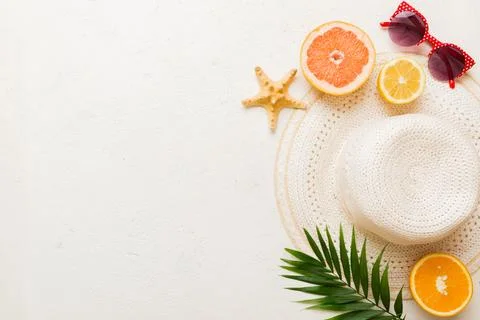 Top view of various seashells placed near colorful fruit and stylish summer a Stock Photos
