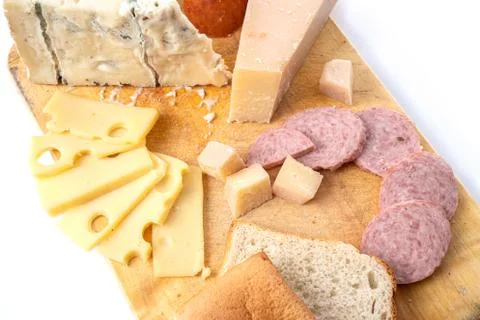 Top view on various type of cheese with bread and sausages on wooden board Stock-Fotos