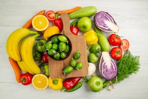 Top view vegetable composition with fruits on the white background color ri.. Stock Photos