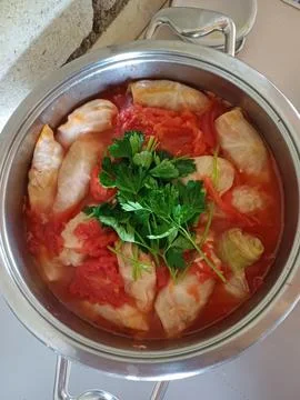 Top view of vegetable-stuffed cabbage rolls in metal pot, ukrainian delight Stock Photos