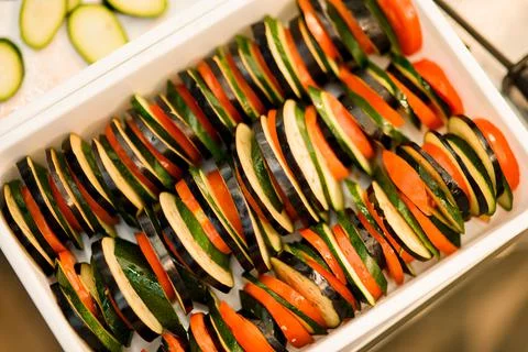 Top view of vegetables cutting into circles and stacked in a row in box Stock Photos