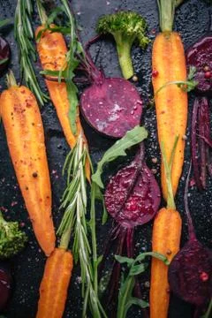 Top view of vegetables for roasting on dark background Stock Photos