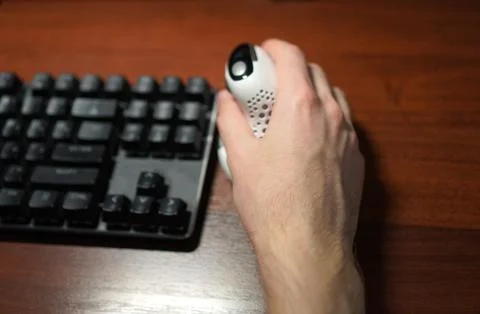 Top view of a vertical computer mouse in the hands of a programmer near the.. Stock-Fotos