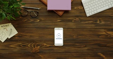 Top view on the vertical smartphone having a program loading on its white screen Stock-Footage 95051416