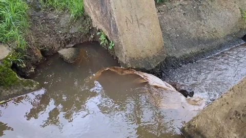 Top view video of flood water flowing rapidly at the spillway gate during a.. Stock Footage 336043954