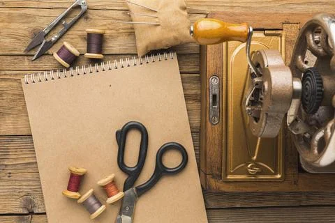 Top view vintage sewing machine with notebook scissors Stock Photos