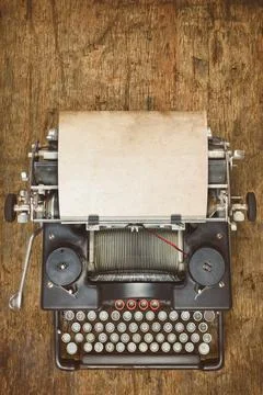 Top view of a vintage typewriter with empty sheet of paper Stock Photos