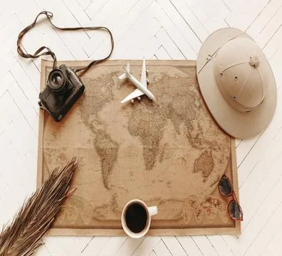 Top view of vintage world map with objects related to journey, excursions and Stock Photos