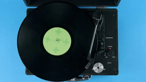Top view of vinyl on Record player blue table and green label Stock Footage 218629736