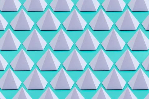 A top view of a violet pentagonal pyramid made of paper on a light blue backg Stock Photos
