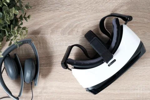 Top view VR virtual reality glasses, headphones and  artificial potted plan.. Stock Photos