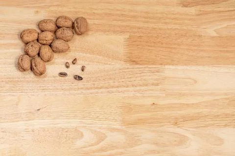 Top view of walnuts and pine nuts with copyspace on a wooden table Stock Photos