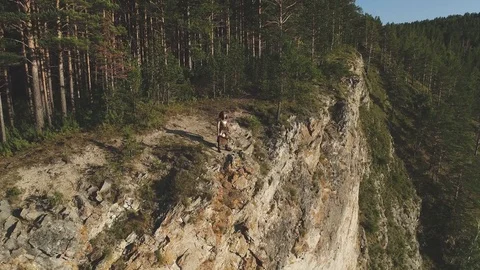 Top view is warrior in old suit on edge of steep bank near forest. Stock Footage 82578022