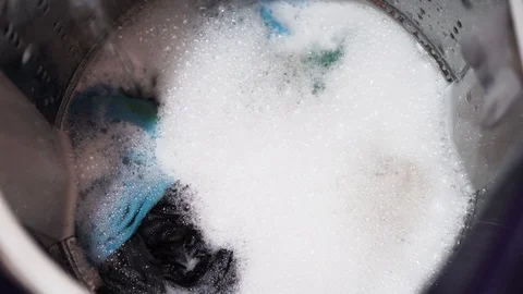 Top view of a washing machine drum during spinning clothes. Top loading Stock Footage 116760898