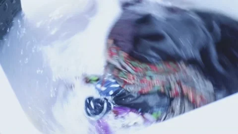 Top view washing machine washes dirty colorful clothes. Stock Footage 157591449