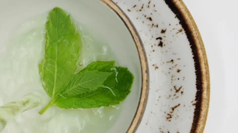 Top View Of Water Being Poured Into A Cup Of Herbal Tea, London, UK Stock Footage 132875689
