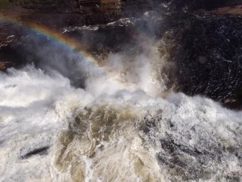 Top view of water falling from a fall with a rainbow Stock Photos
