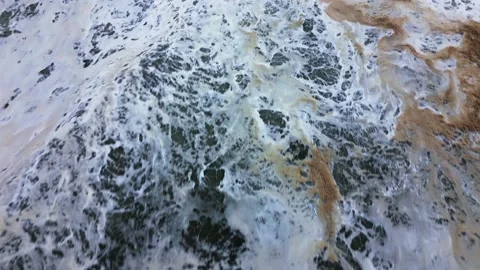 Top view of the water full of foam and sand. Background Stock Footage 230158466