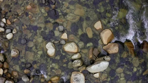 Top view of a waterbed full of rocks in different shapes and colors Stock Footage 151279760