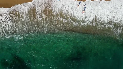 Top view wave crashing to the sandy beach Stock Footage 229457762