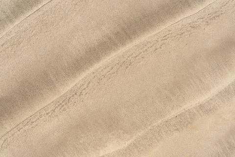 Top view of wave pattern on sandy beach background Stock Photos