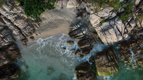 Top view of Wave  with the rocks and  sand beach Video stock 168073734