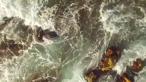 Top View Waves and Rocks Top VIew Pull Out To Wide Shot -  Aerial Stock Footage 72152332
