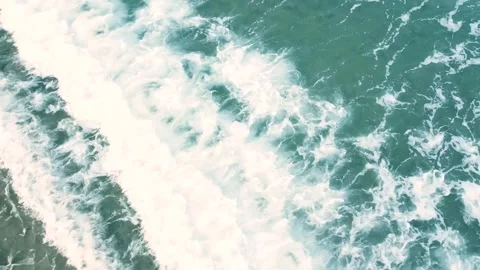 Top view of waves arriving at the shore of a beach with a calm sea. Stock Footage 277954783