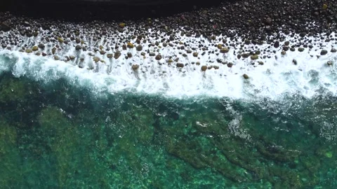 Top view of waves breaking on the unspoiled beach pebble shore Stock Footage 278799314