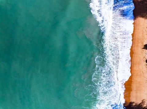 Top view waves crashing on sandy shore, Beach sea space nature background Stock Photos