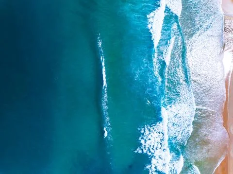 Top view waves crashing on sandy shore, Beach sea space nature background Stock Photos