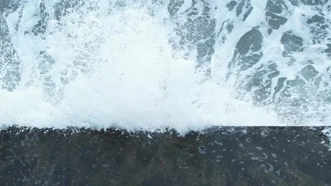 Top view of waves crashing on a wall and splashing. Slow motion. Stock Footage 145953725