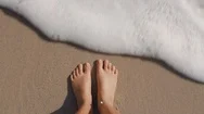 Top View Waves Gently Splashing Feet Woman Standing Barefoot On Beach Enjoying Stock Footage