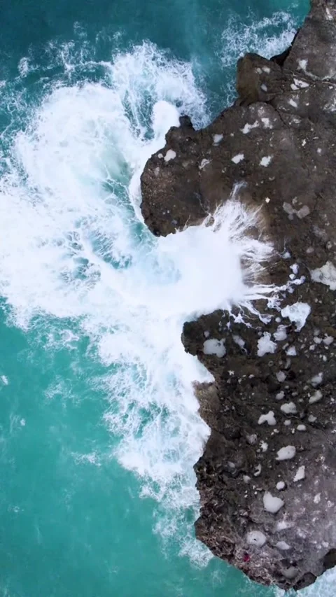 Top View of Waves Hitting Black Rocks on the Coast Stock Footage 311308590