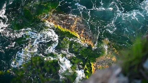 Top view of waves hitting by rocks. Beautiful ocean waves slow motion. Stock Footage 128897920